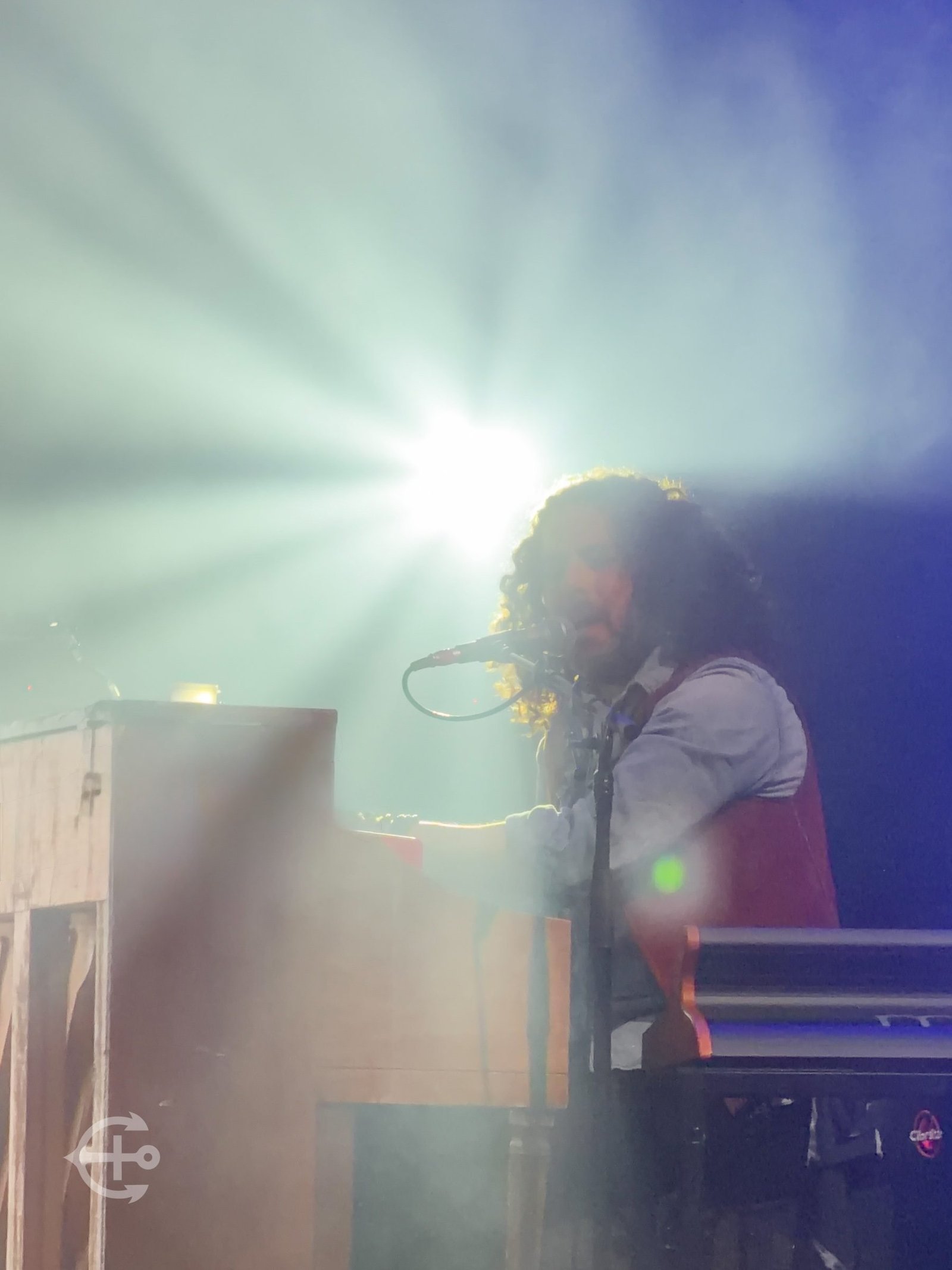 Performer silhouetted by bright stage lighting