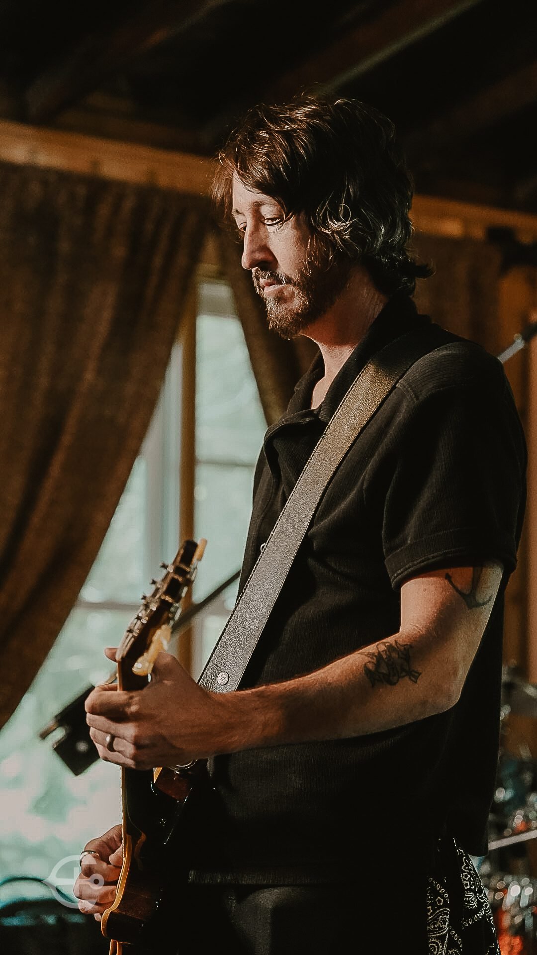 Guitarist performing in an intimate rehearsal space