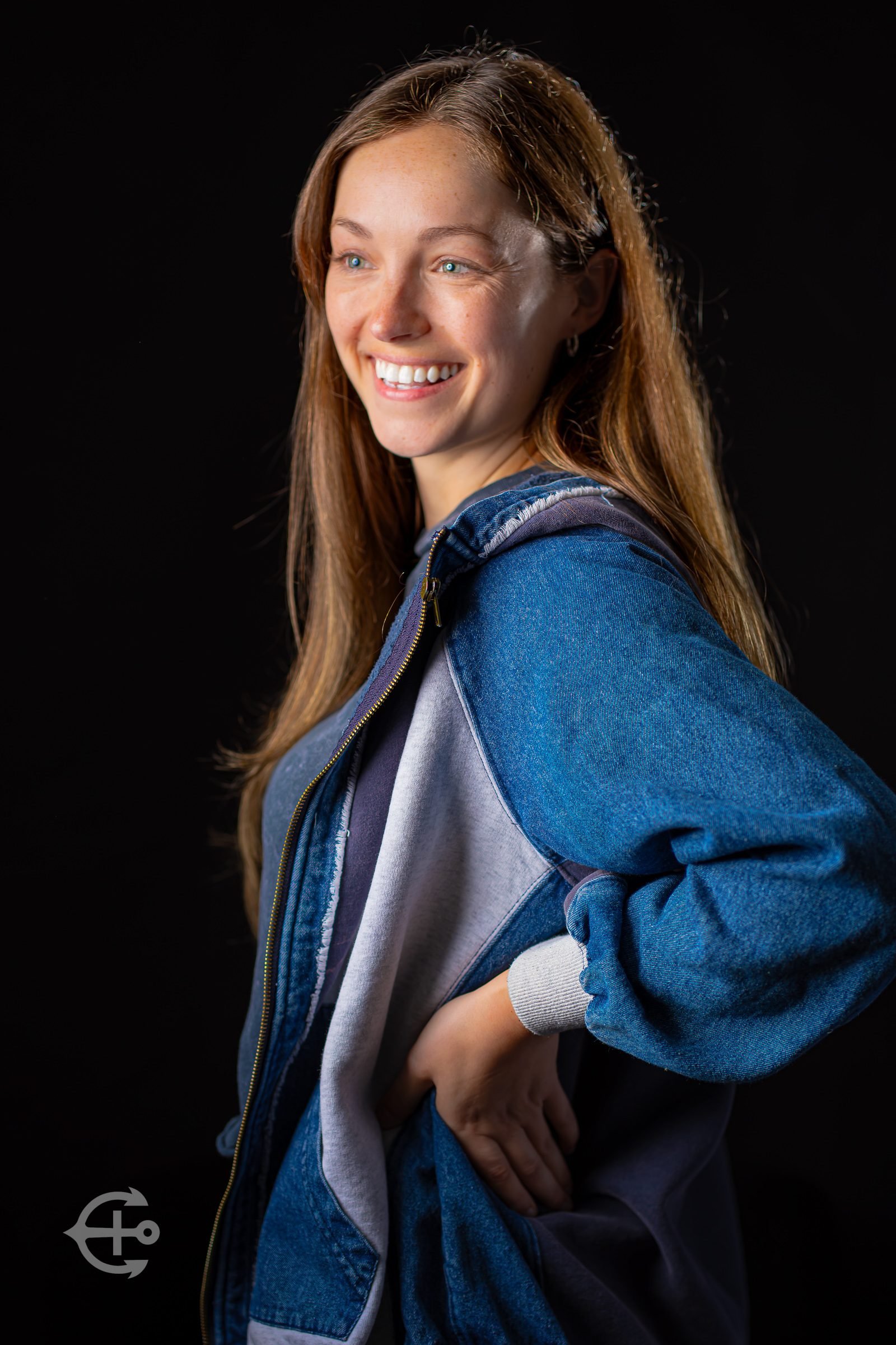 Young woman smiling in a full-length studio portrait