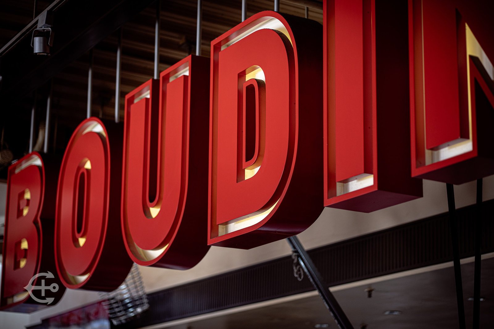 Close architectural detail of the red Boudin bakery sign