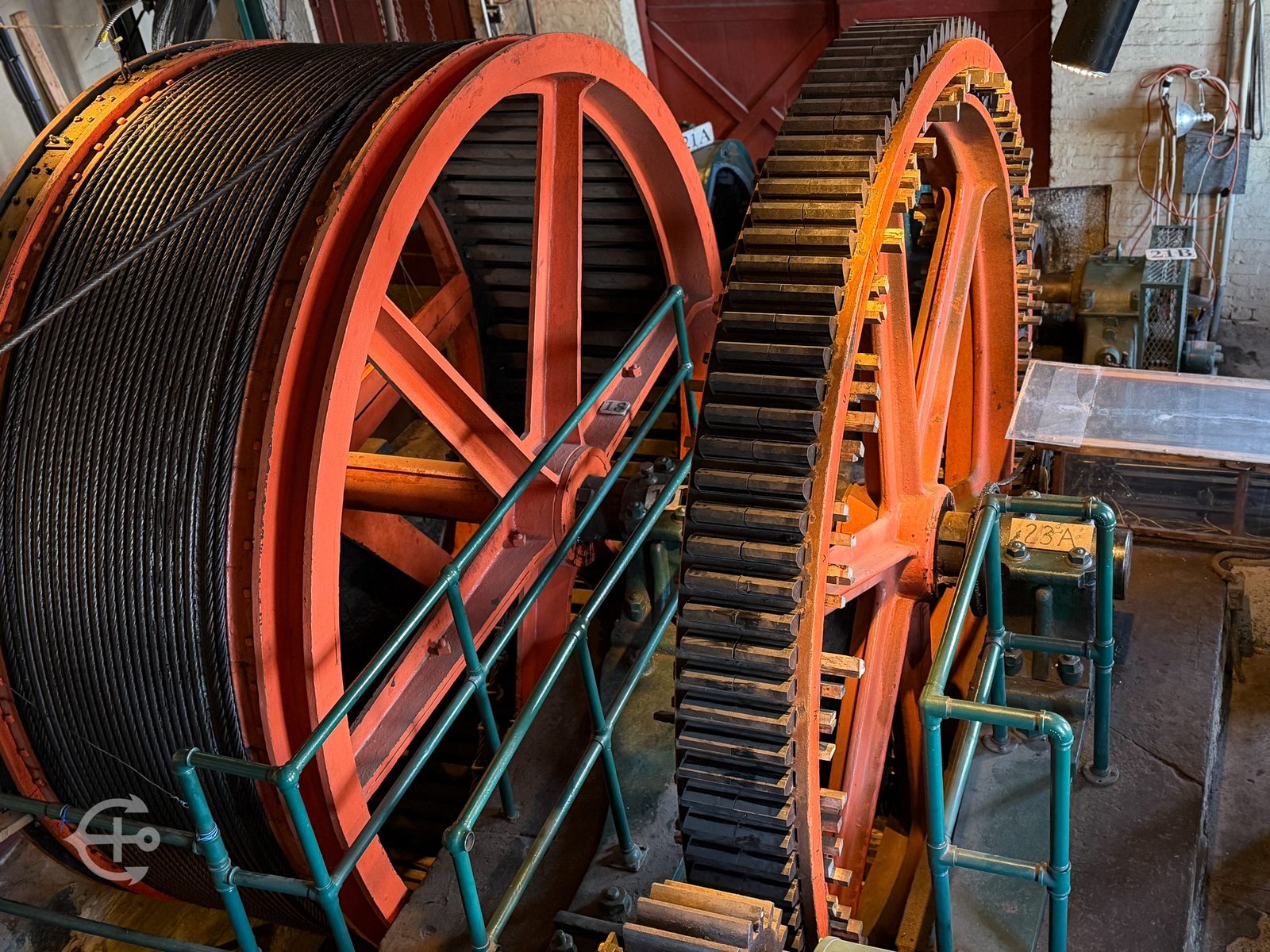 Large colorful industrial gears inside a historic facility