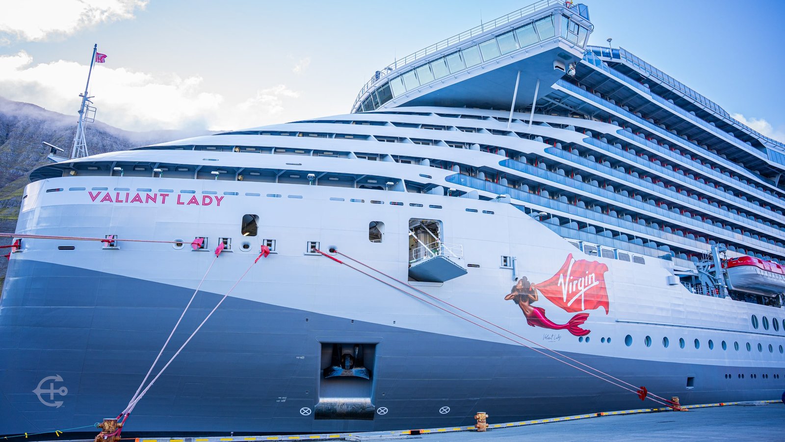 Close view of Valiant Lady and its Virgin hull artwork at the dock