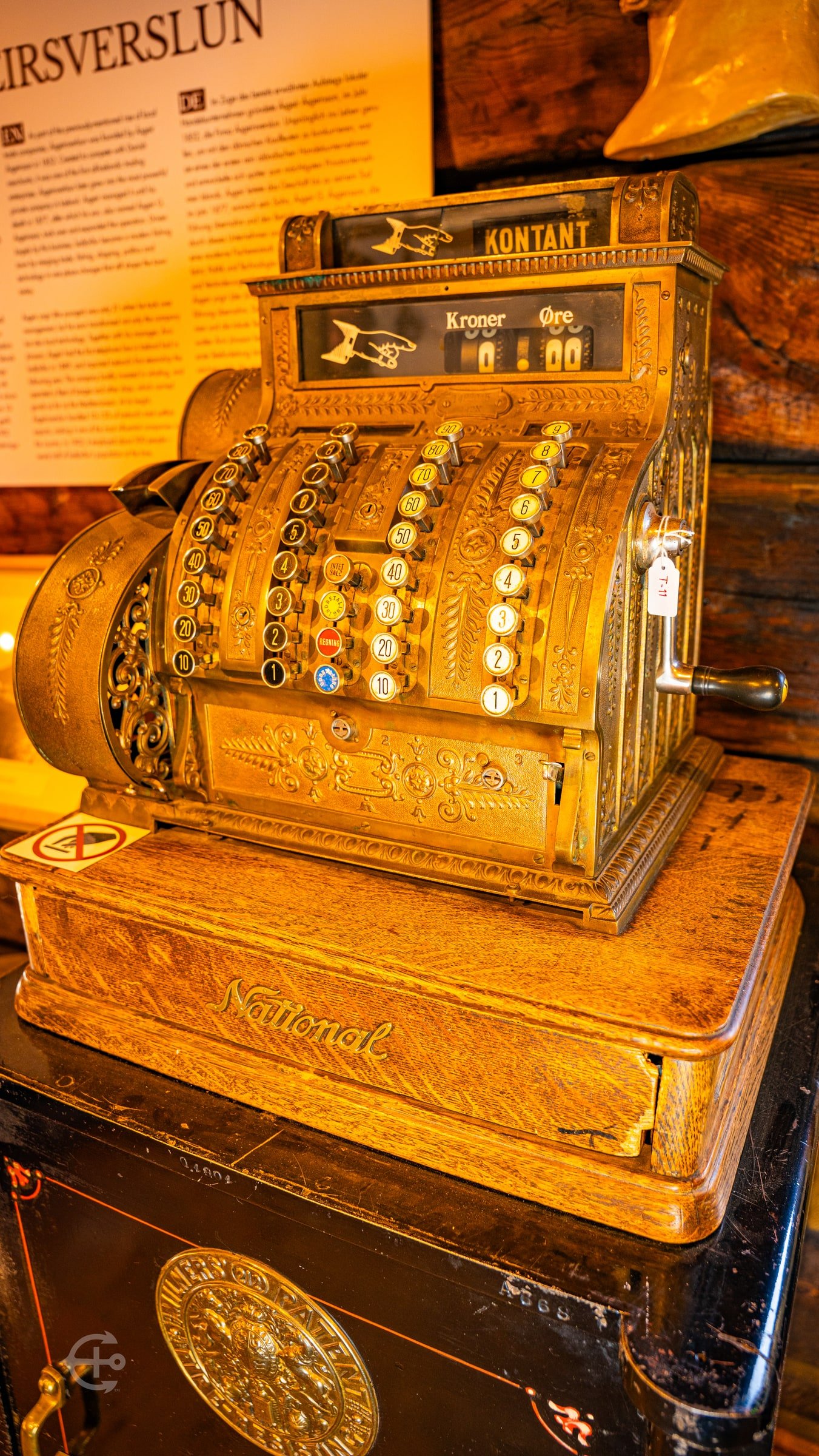 Ornate antique brass cash register in warm indoor light