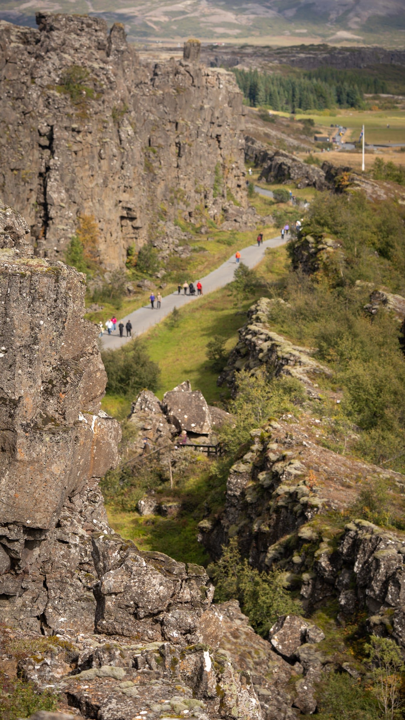 Visitors walking between tall rock walls