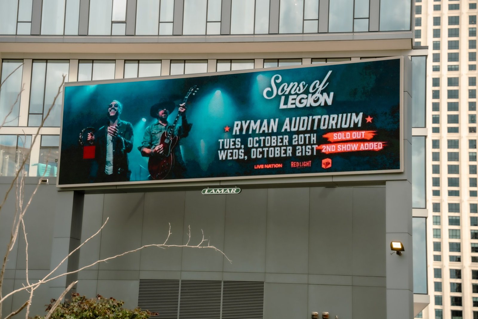 Sons of Legion Ryman Auditorium promotion displayed on a Nashville building billboard